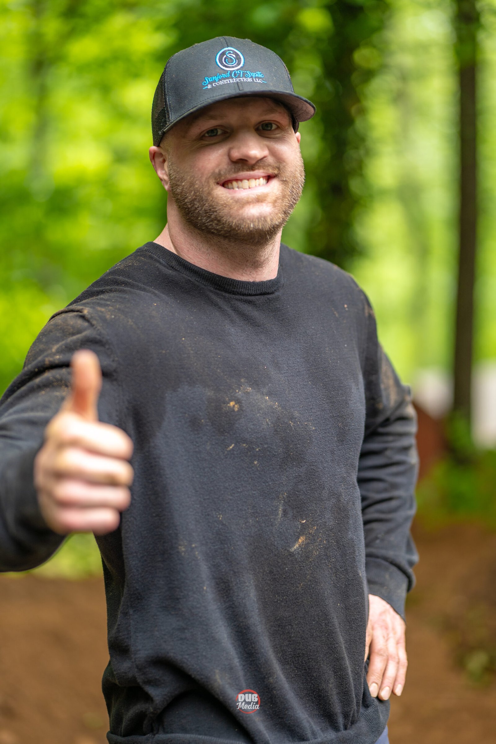 man smiling with thumbs up